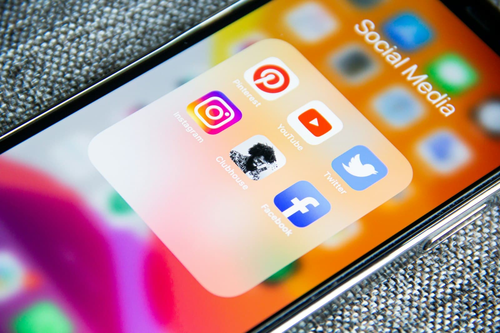 Phone screen showing social media apps used for organic social marketing.