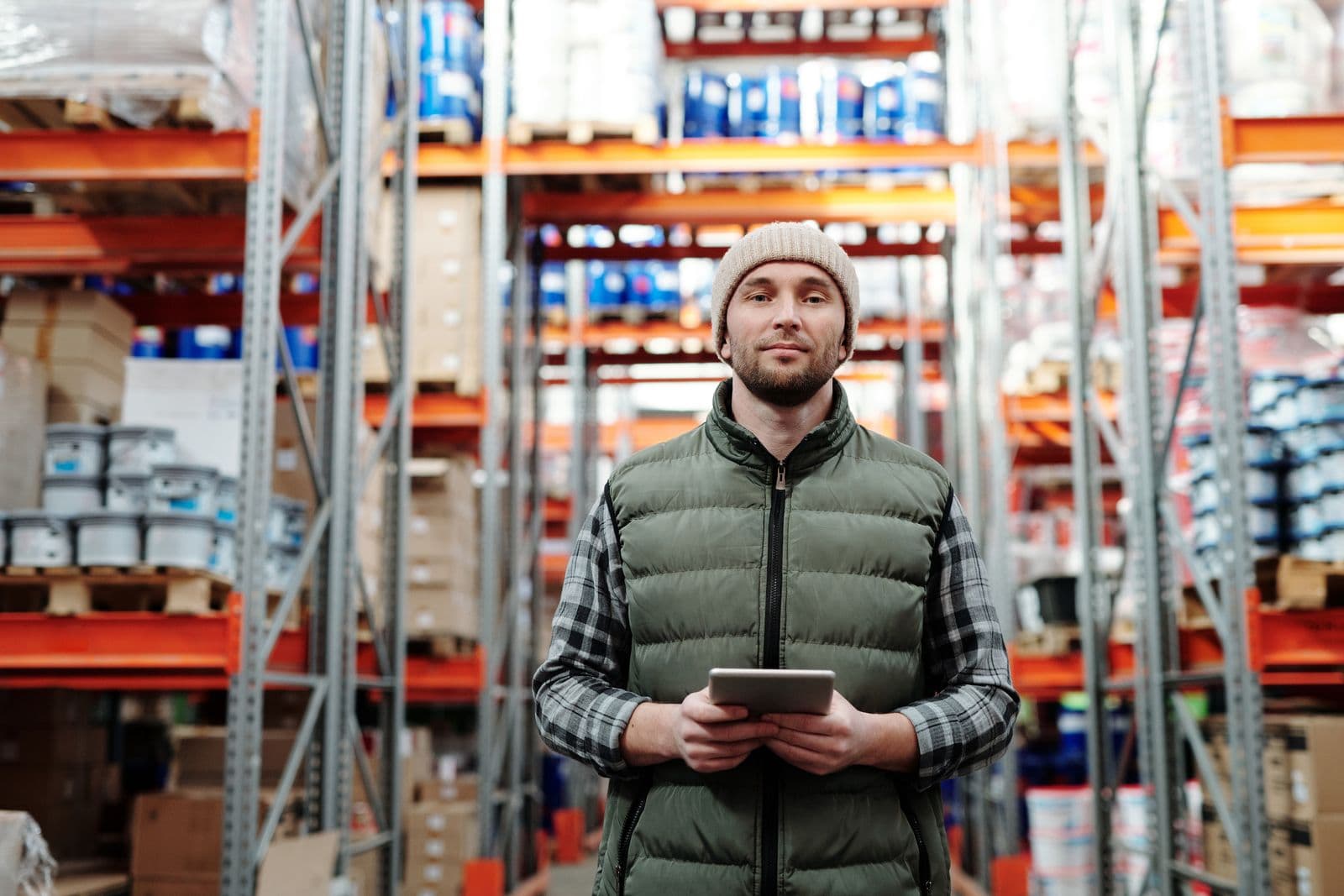 A warehouse team member with a tablet on the shop floor.