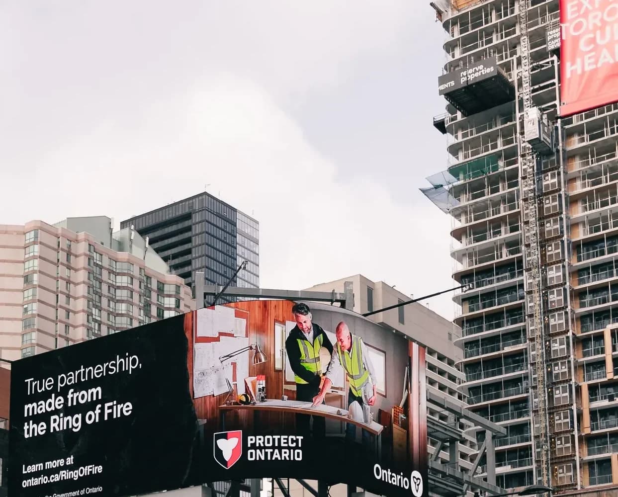 Large digital billboard above a busy city street.