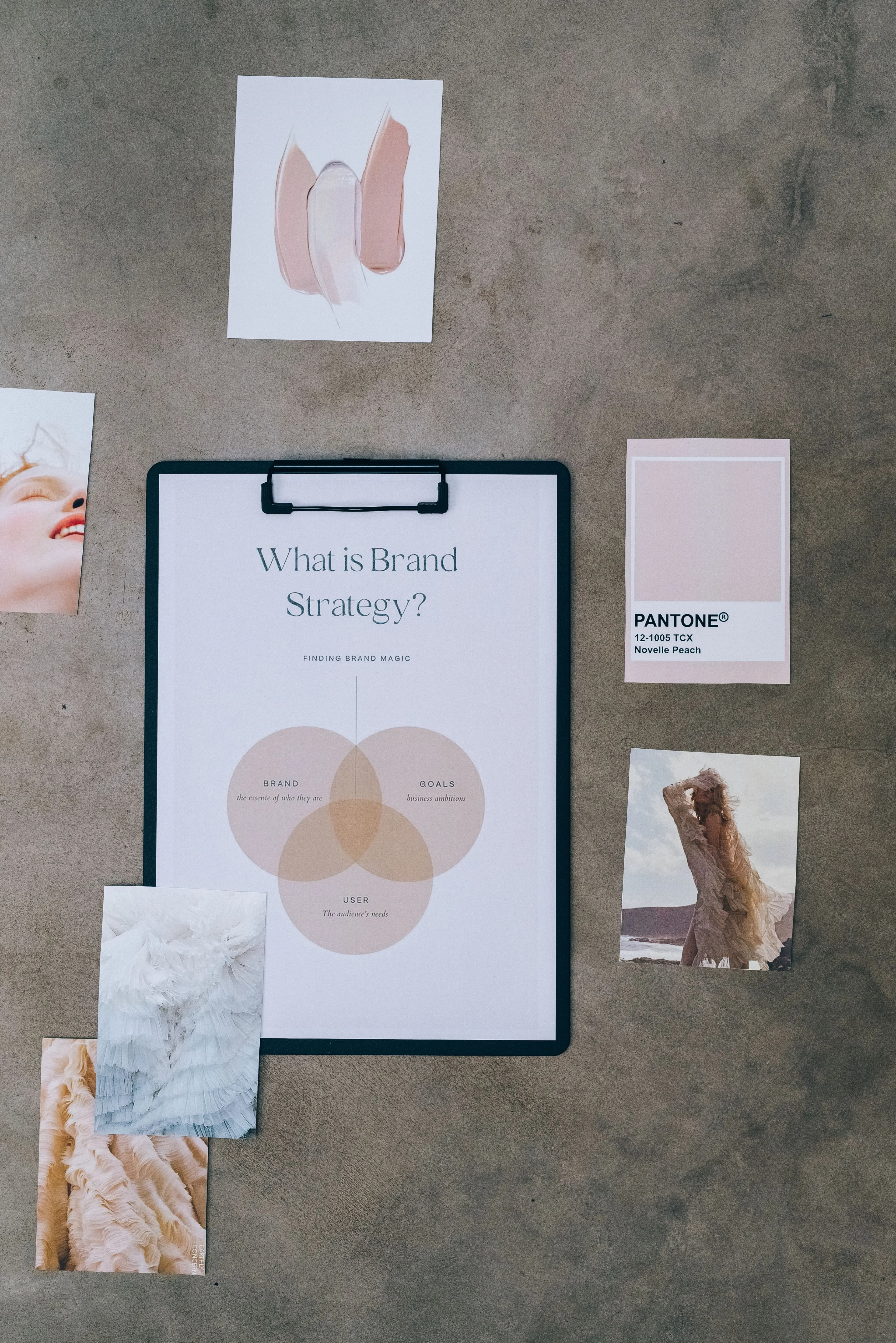 Creative desk with a brand-strategy board, colour swatches and reference photography.