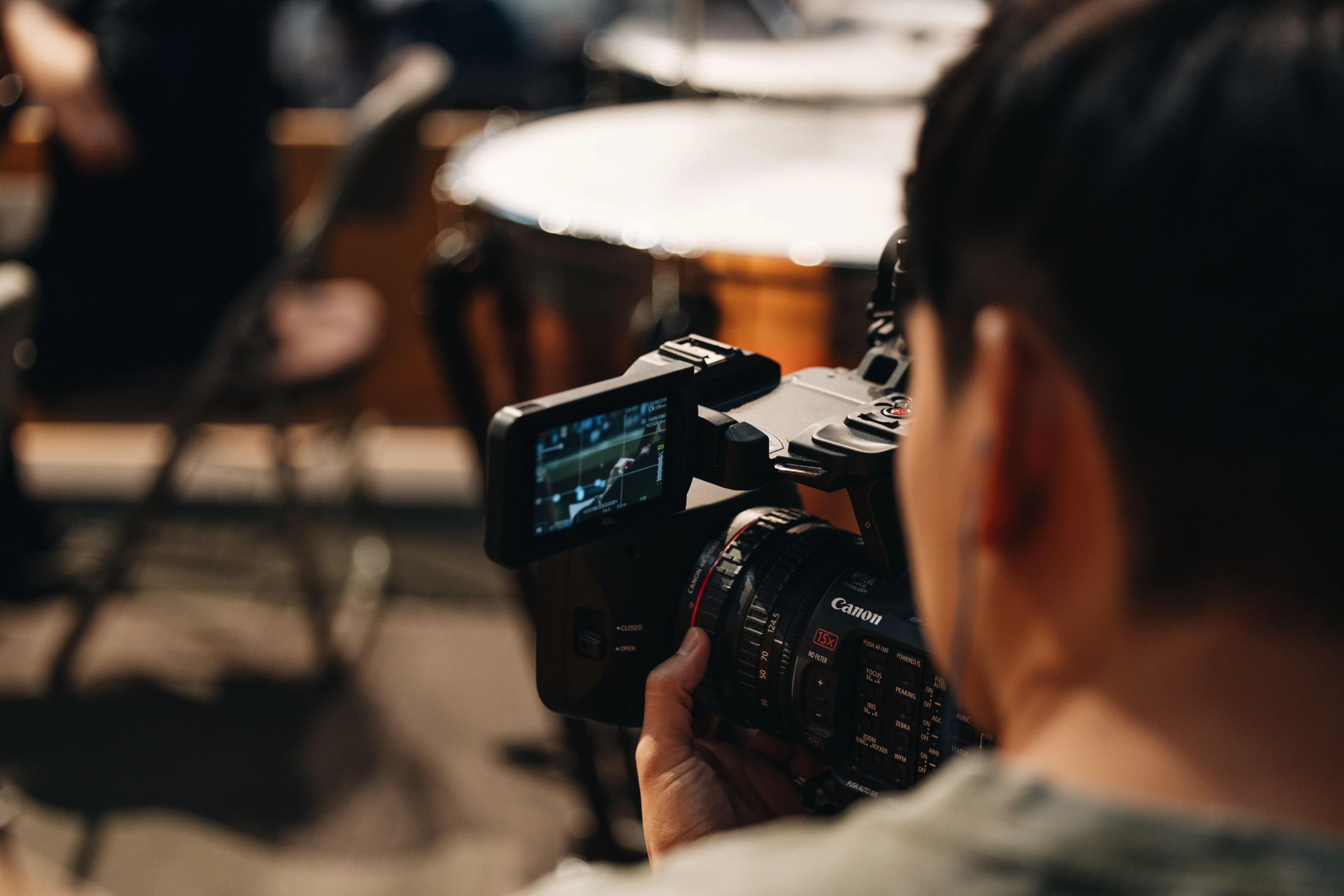 Videographer operating a professional camera during a production shoot.