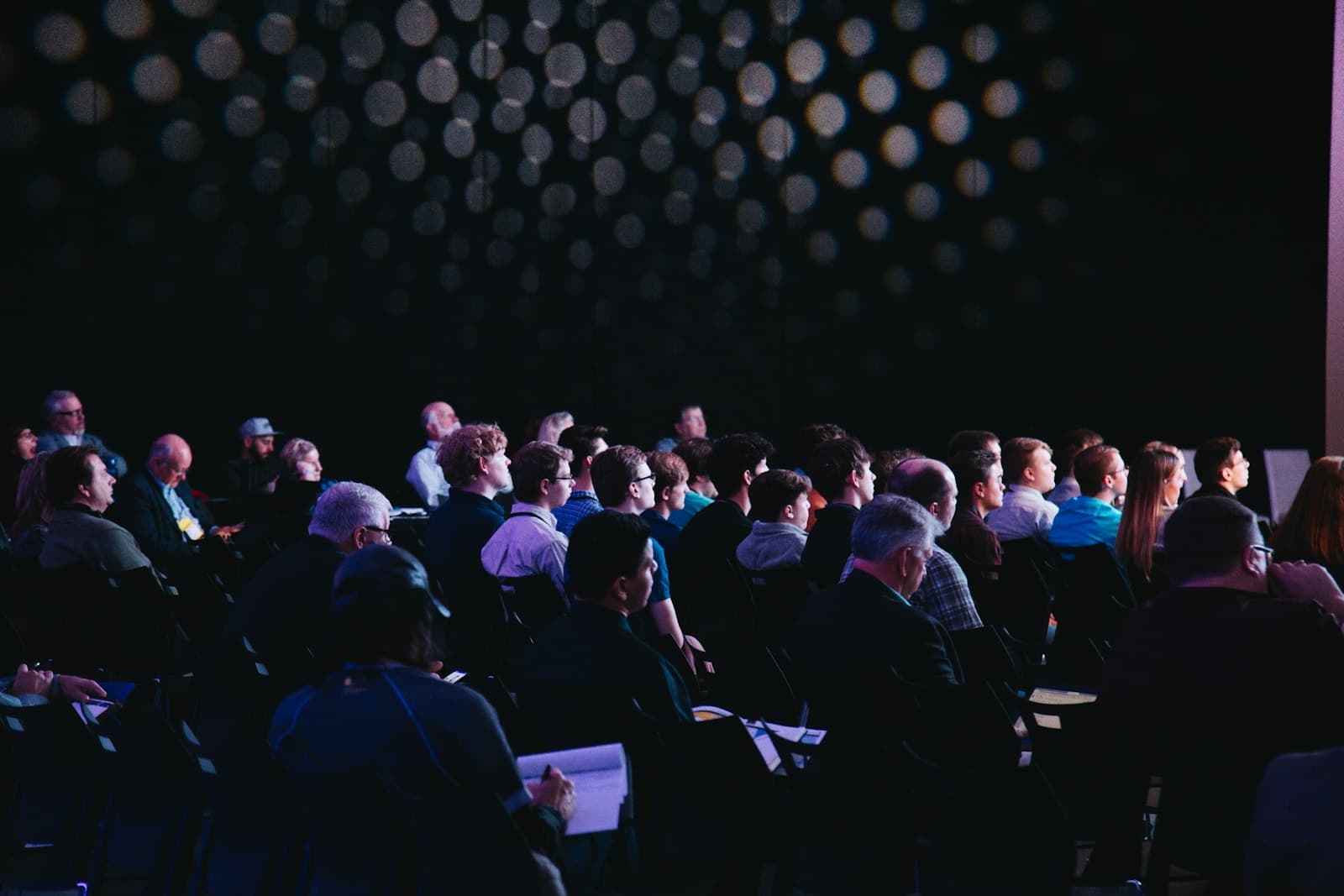 An audience seated at a branded corporate event.