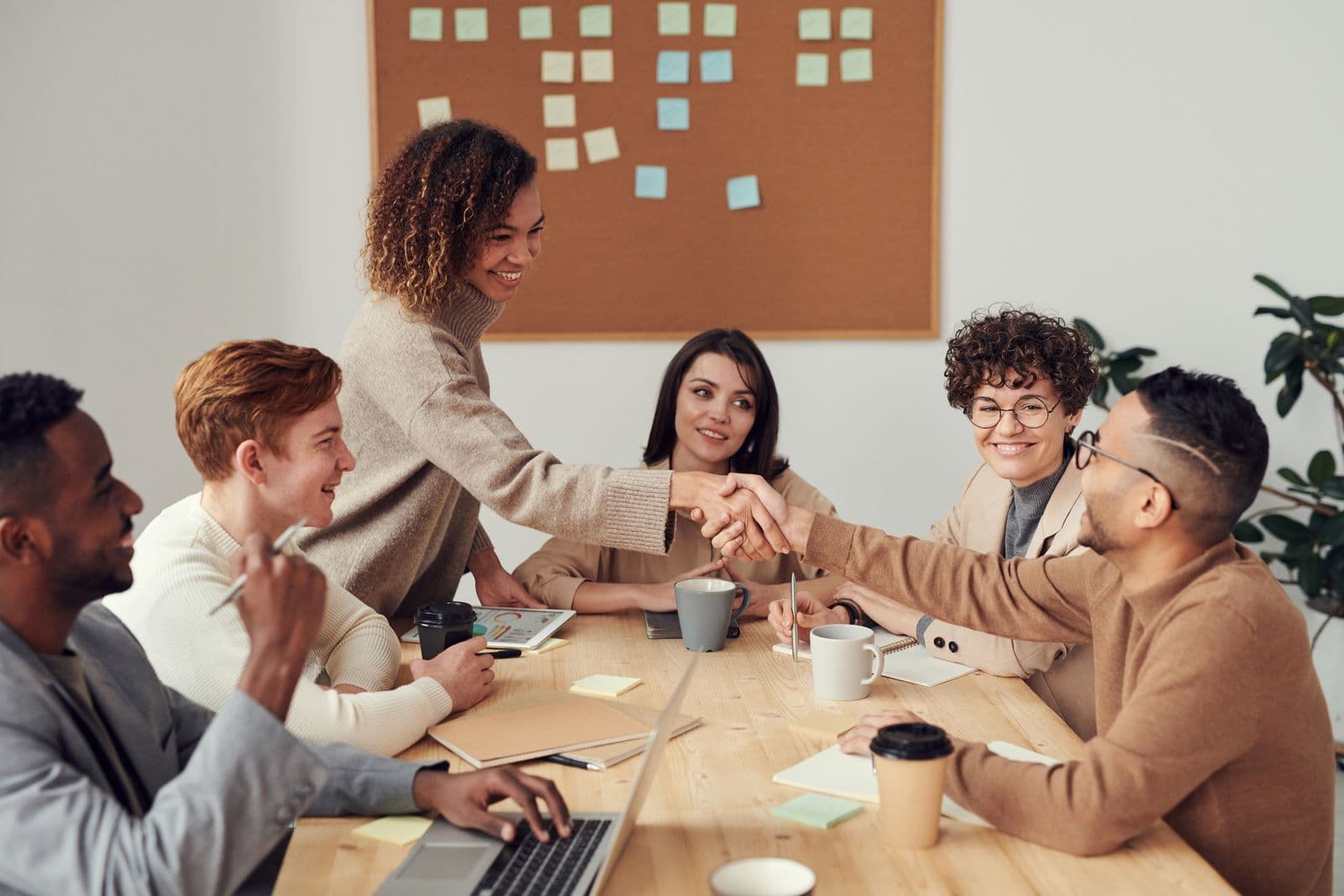 Colleagues around a meeting table agreeing a hire.