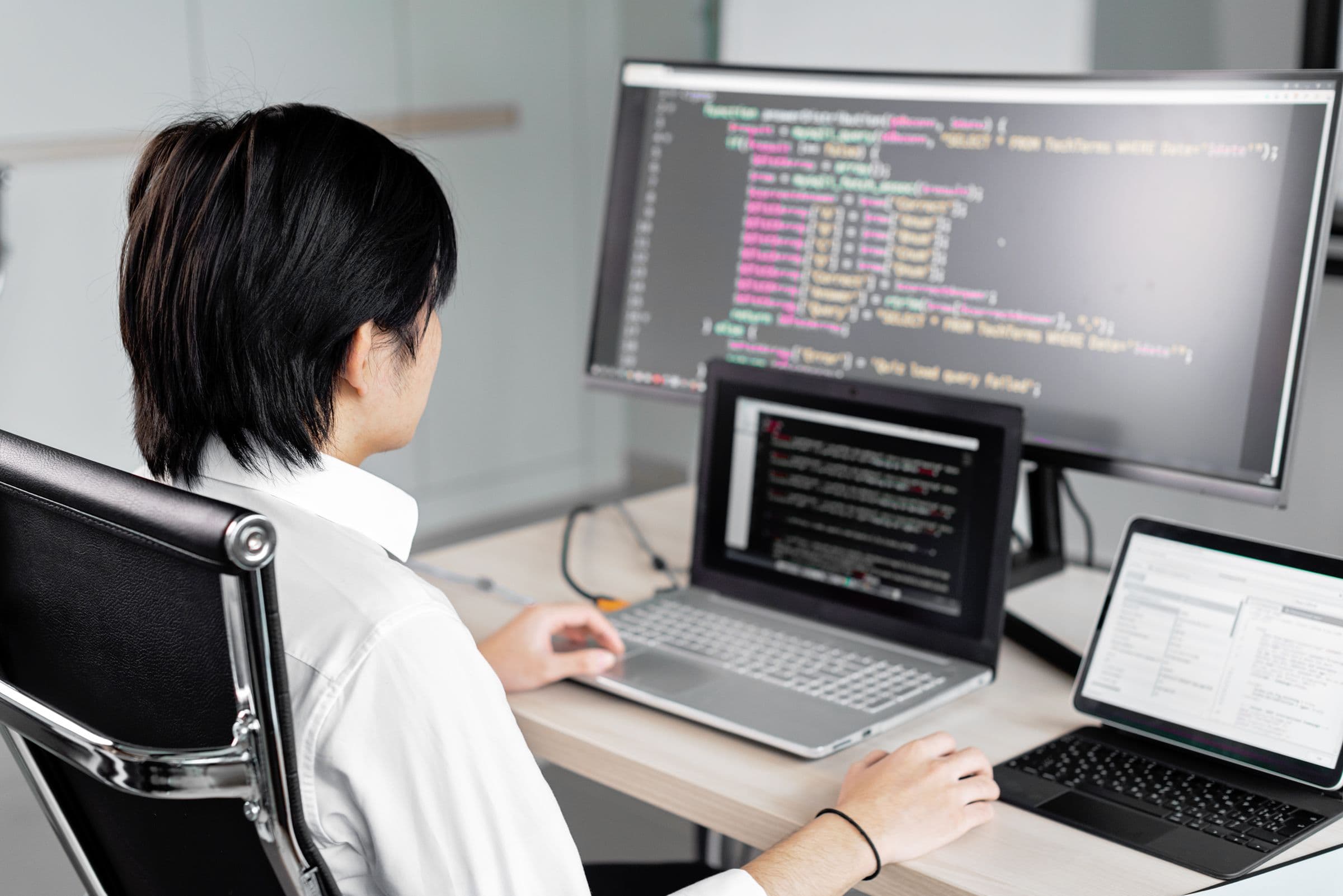 Developer workstation with application interfaces on screen.