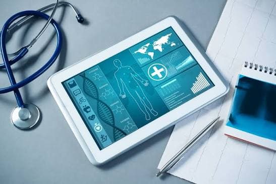Tablet showing a healthcare dashboard beside a stethoscope.